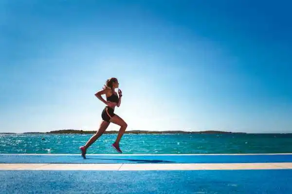 Woman running showing strong leg muscle Netherton